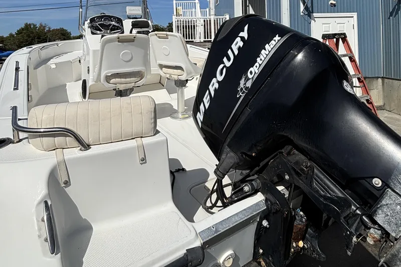 Slide: The Image of 2010 Mako 184 Center Console boat with Mercury OptiMax engine, docked outdoors. - 4