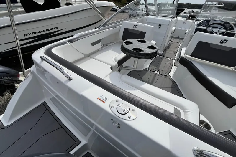 Slide: The Image of 2023 Hurricane SunDeck 235 OB boat interior with seating and table, showcasing modern design. - 11