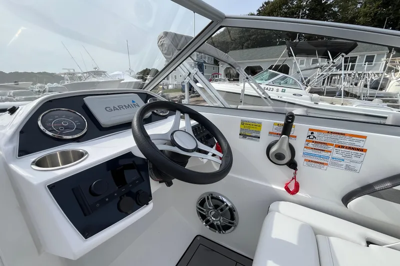 Slide: The Image of 2023 Hurricane SunDeck 235 OB boat dashboard with Garmin navigation system. - 12