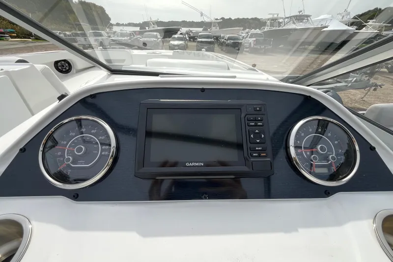 Slide: The Image of Dashboard of 2023 Hurricane SunDeck 235 OB boat with Garmin display and gauges. - 13
