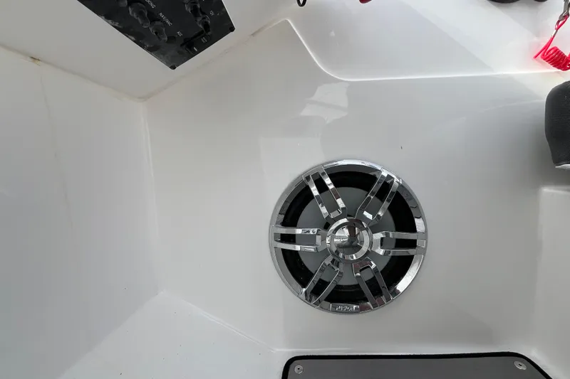 Slide: The Image of 2023 Hurricane SunDeck 235 OB boat speaker with chrome grille in white interior. - 17