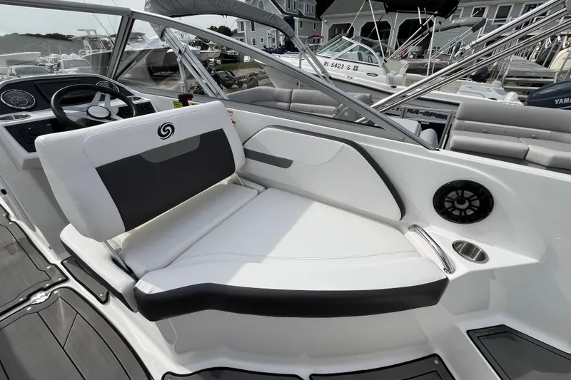 Slide: The Image of 2023 Hurricane SunDeck 235 OB boat interior with sleek seating and modern dashboard. - 19