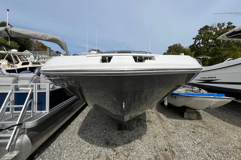 Slide: The Image of 2023 Hurricane SunDeck 235 OB boat displayed on gravel lot. - 2