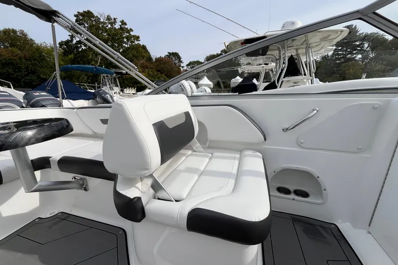 Slide: The Image of 2023 Hurricane SunDeck 235 OB boat interior with white seating and sleek design. - 20