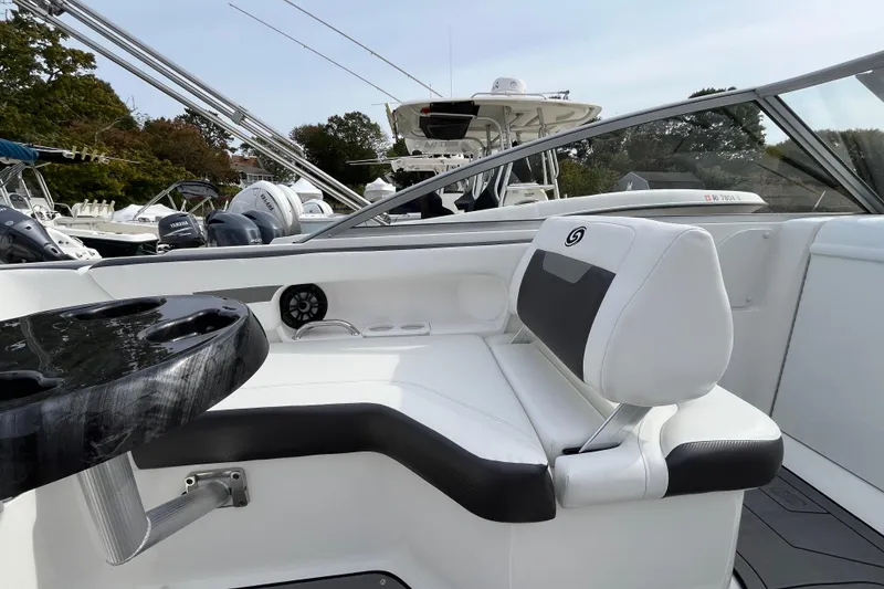 Slide: The Image of 2023 Hurricane SunDeck 235 OB boat interior with white seating and black table. - 21