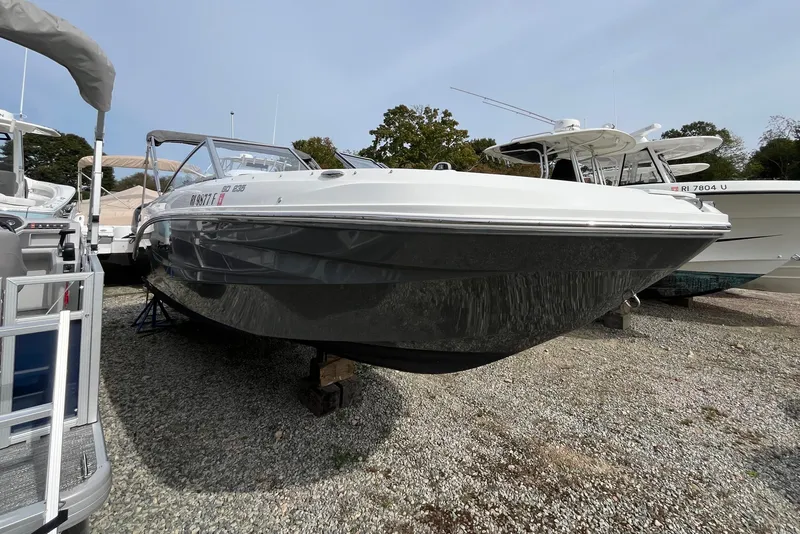 Slide: The Image of 2023 Hurricane SunDeck 235 OB boat displayed on gravel lot. - 3