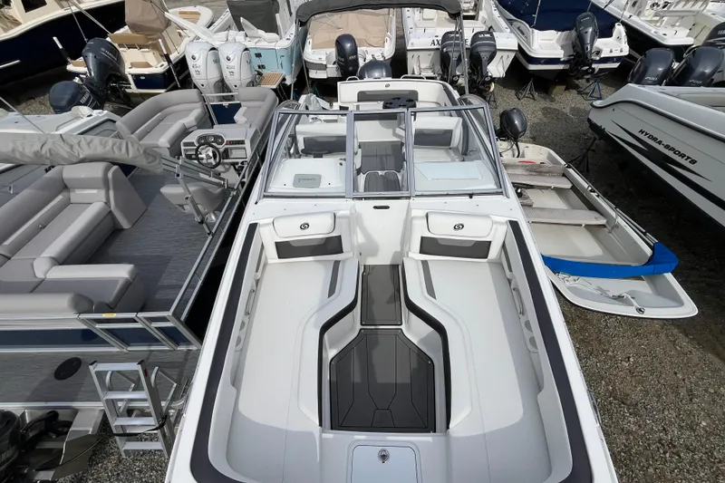 Slide: The Image of 2023 Hurricane SunDeck 235 OB boat, top view, docked among other boats. - 30