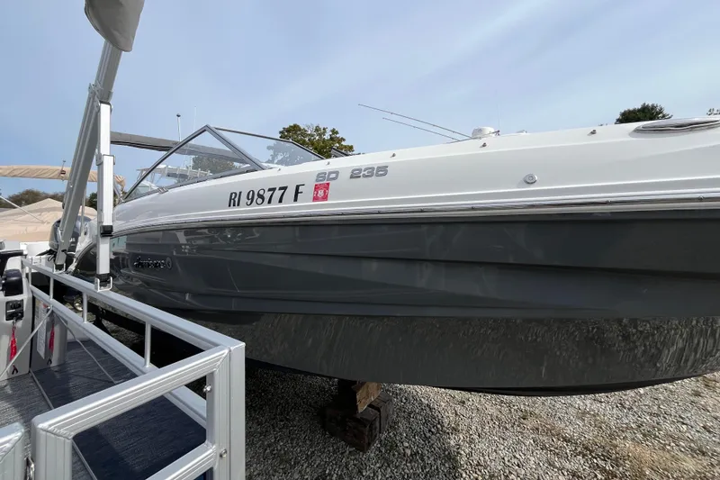 Slide: The Image of 2023 Hurricane SunDeck 235 OB boat on display, side view with registration number. - 4