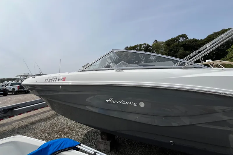 Slide: The Image of 2023 Hurricane SunDeck 235 OB boat on trailer, parked outdoors. - 5