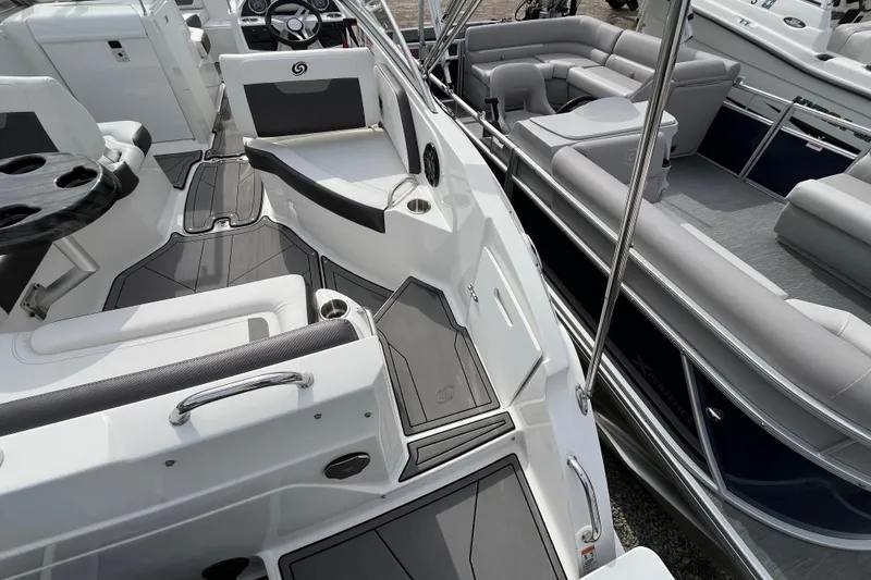 Slide: The Image of 2023 Hurricane SunDeck 235 OB boat interior with sleek seating and modern design. - 9
