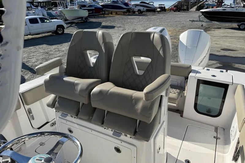 Slide: The Image of 2022 Sportsman Open 262 Center Console boat with dual helm seats and steering wheel. - 10
