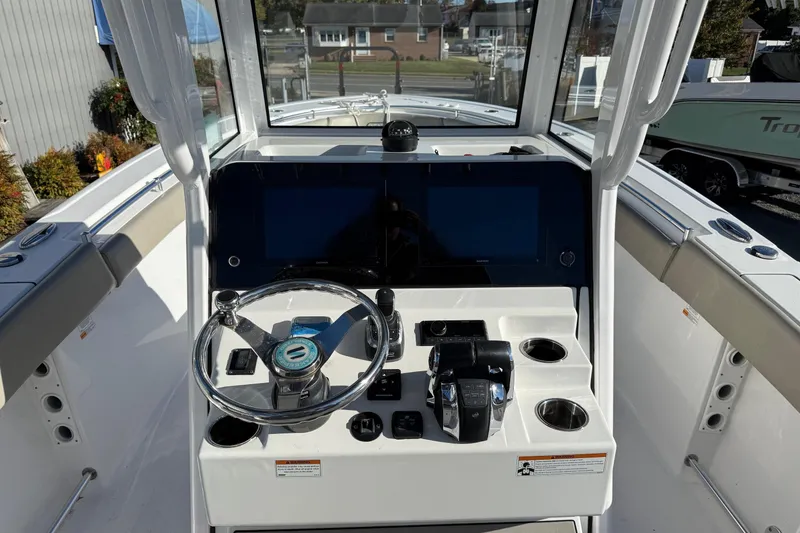 Slide: The Image of 2022 Sportsman Open 262 Center Console boat dashboard with steering wheel and controls. - 11