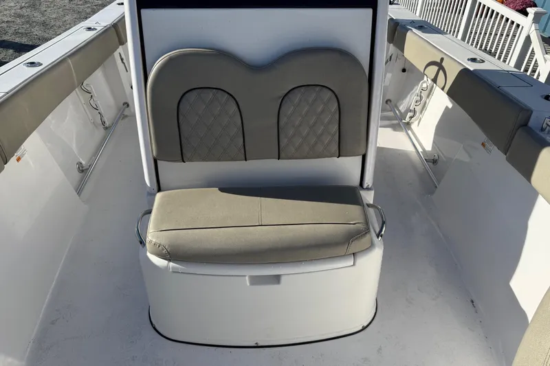 Slide: The Image of 2022 Sportsman Open 262 Center Console boat seating area with cushioned bench. - 13