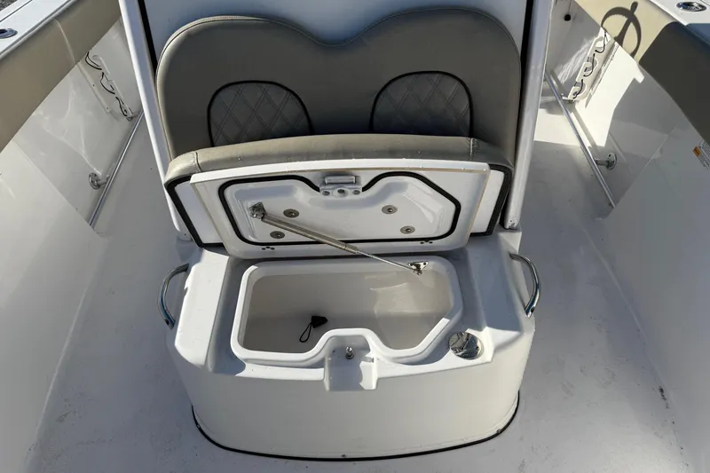 Slide: The Image of 2022 Sportsman Open 262 Center Console boat seat with open storage compartment. - 14