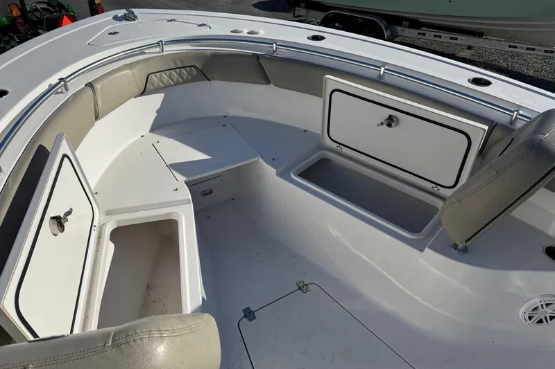 Slide: The Image of 2022 Sportsman Open 262 Center Console boat interior with storage compartments and seating. - 17
