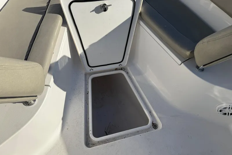 Slide: The Image of 2022 Sportsman Open 262 Center Console boat interior with storage compartment and seating. - 18