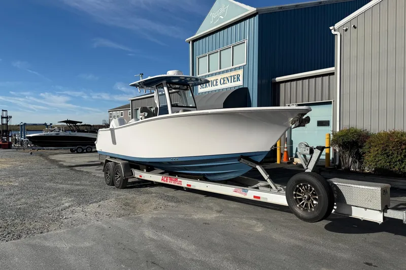 Slide: The Image of 2022 Sportsman Open 262 Center Console boat on trailer outside service center. - 4