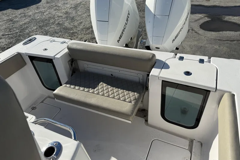 Slide: The Image of 2022 Sportsman Open 262 Center Console boat with dual Mercury engines and cushioned seating. - 6