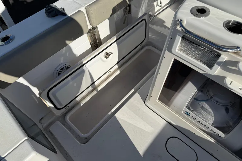 Slide: The Image of 2022 Sportsman Open 262 Center Console interior with storage compartment and Seakeeper system. - 8