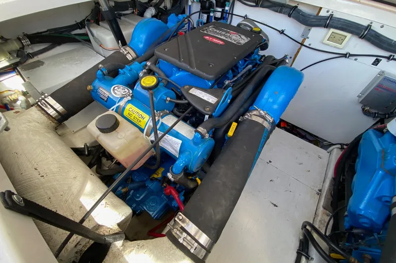 Slide: The Image of Engine compartment of a 2004 Tiara Yachts 3200 Open, showcasing blue marine engine components. - 15