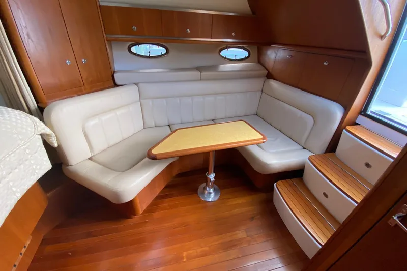 Slide: The Image of Luxurious interior of 2004 Tiara Yachts 3200 Open with plush seating and wooden accents. - 17