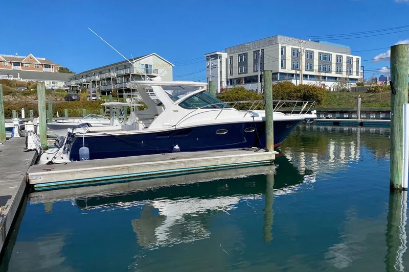 Slide: The Image of 2004 Tiara Yachts 3200 Open docked in a marina under clear blue skies. - 18