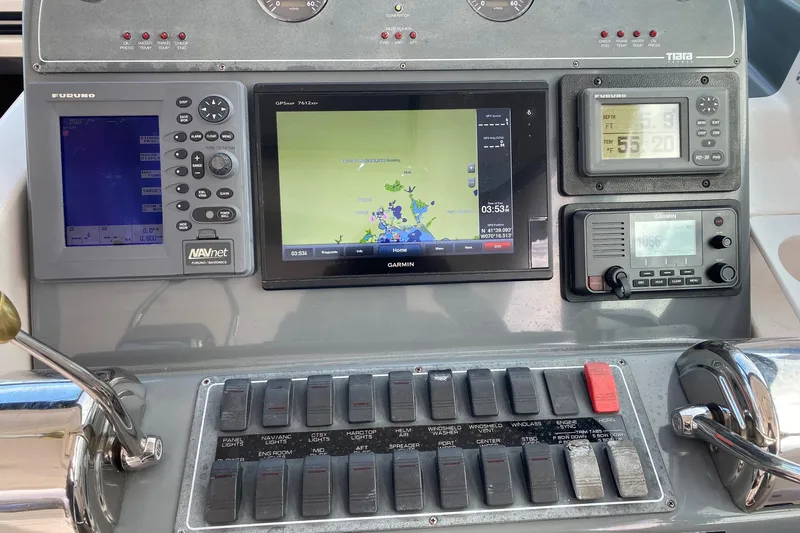 Slide: The Image of Dashboard of a 2004 Tiara Yachts 3200 Open with navigation and control systems. - 27