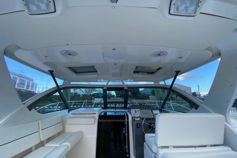 Slide: The Image of 2004 Tiara Yachts 3200 Open cockpit with helm, seating, and navigation equipment. - 5