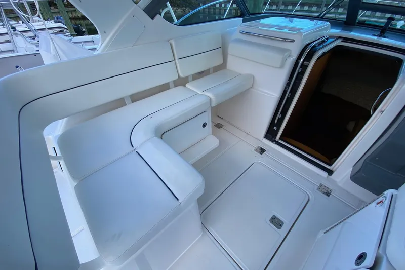 Slide: The Image of 2004 Tiara Yachts 3200 Open interior with white seating and cabin entrance. - 7