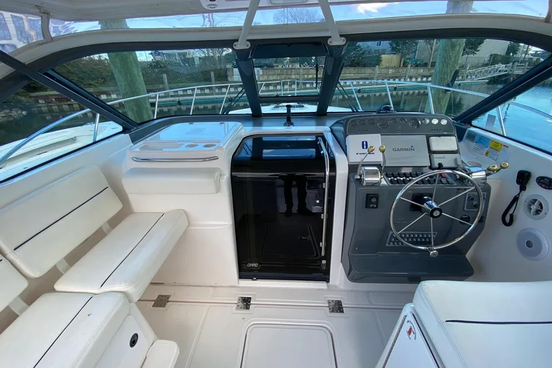 Slide: The Image of 2004 Tiara Yachts 3200 Open cockpit with steering wheel and navigation equipment. - 8