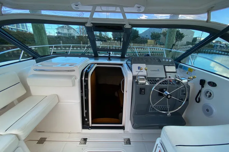 Slide: The Image of 2004 Tiara Yachts 3200 Open cockpit with steering wheel and navigation equipment. - 9