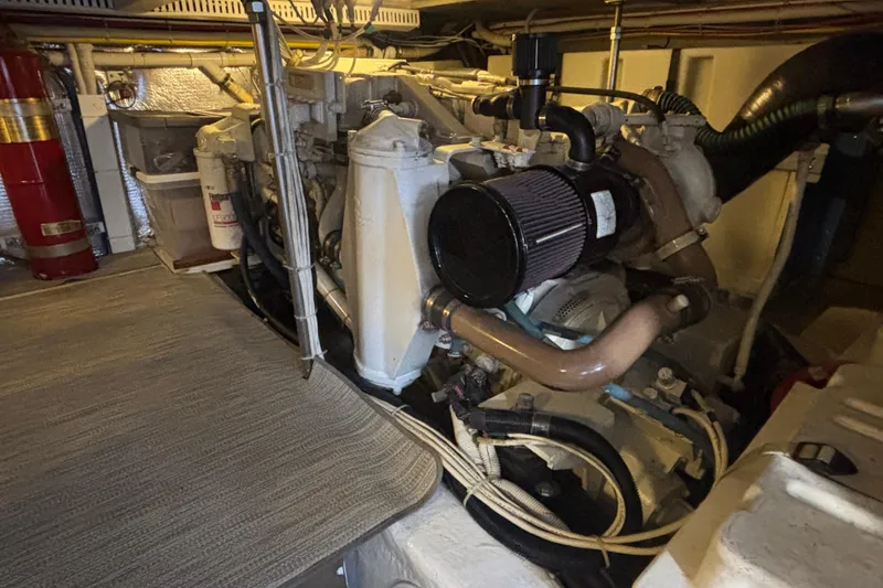Slide: The Image of Engine room of a 2003 Carver 450 Voyager Pilothouse with visible components and fire extinguisher. - 22