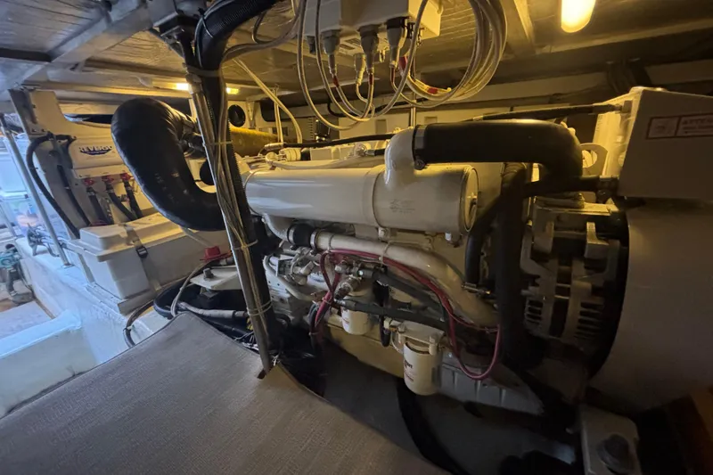 Slide: The Image of Engine room of 2003 Carver 450 Voyager Pilothouse with visible machinery and wiring. - 25