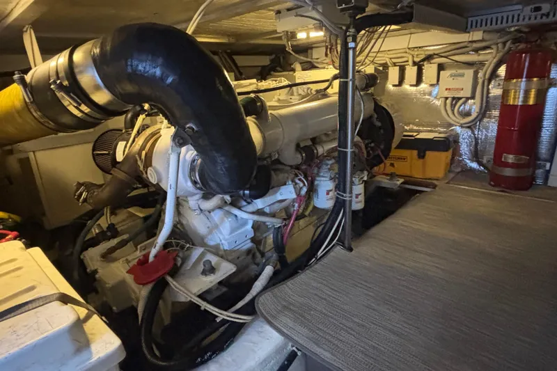 Slide: The Image of Engine room of 2003 Carver 450 Voyager Pilothouse with visible machinery and equipment. - 23