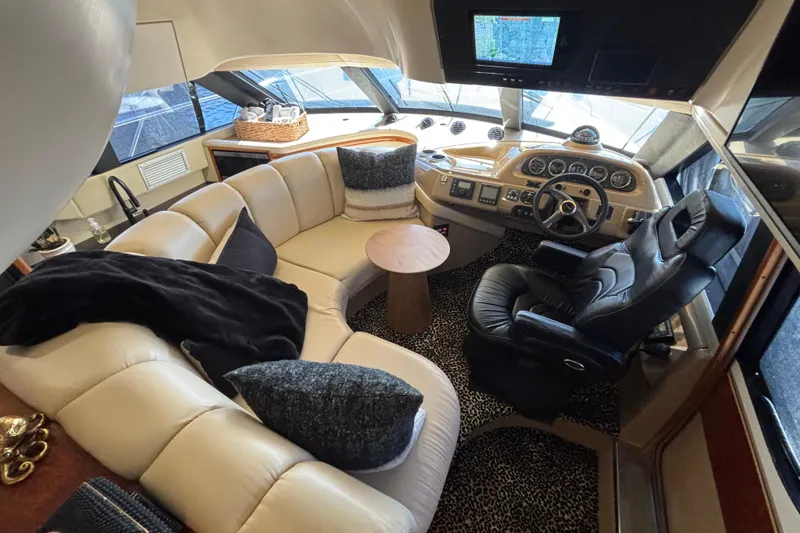 Slide: The Image of 2003 Carver 450 Voyager Pilothouse yacht interior with seating, table, and sink. - 7