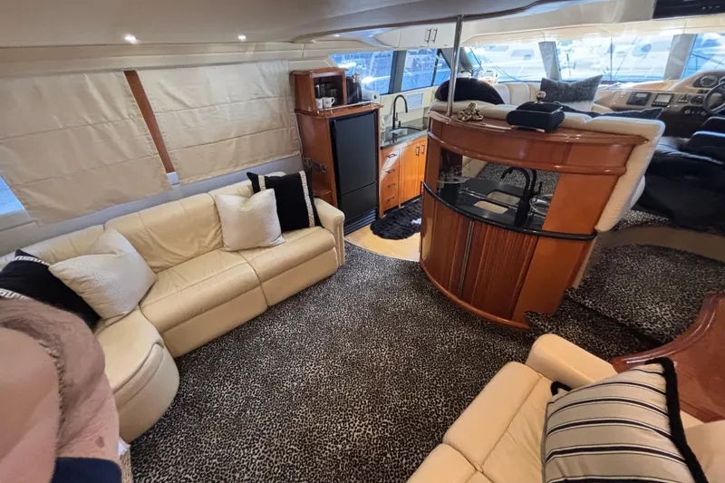 Slide: The Image of 2003 Carver 450 Voyager Pilothouse boat deck with teak flooring and seating area. - 8