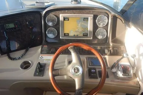 Slide: The Image of Dashboard of 2008 Sea Ray 380 Sundancer with GPS and wooden steering wheel. - 11