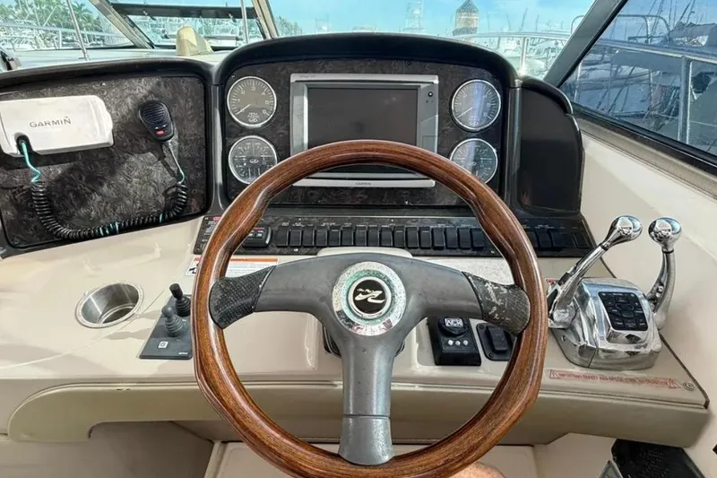 Slide: The Image of 2008 Sea Ray 38 Sundancer helm with Garmin system and wooden steering wheel. - 13