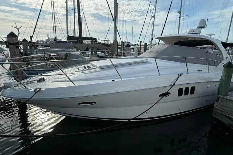 Slide: The Image of 2008 Sea Ray 38 Sundancer yacht docked at marina under clear sky. - 2
