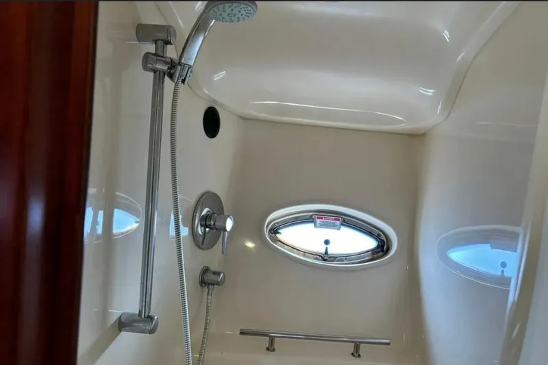 Slide: The Image of Shower area in 2008 Sea Ray 38 Sundancer yacht with oval window and chrome fixtures. - 23