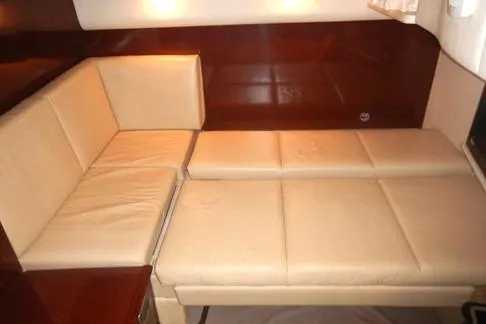 Slide: The Image of 2008 Sea Ray 380 Sundancer interior with beige leather seating and wooden accents. - 26