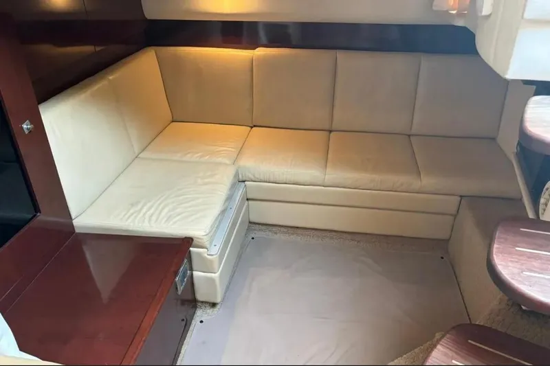 Slide: The Image of 2008 Sea Ray 38 Sundancer interior with beige leather seating and wooden accents. - 28