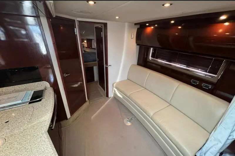 Slide: The Image of Interior of 2008 Sea Ray 38 Sundancer yacht with beige sofa and wooden cabinetry. - 29