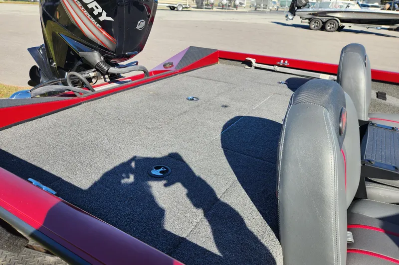 Slide: The Image of 2016 Ranger RT188 boat interior with Mercury engine, featuring gray seating and carpeted deck. - 15