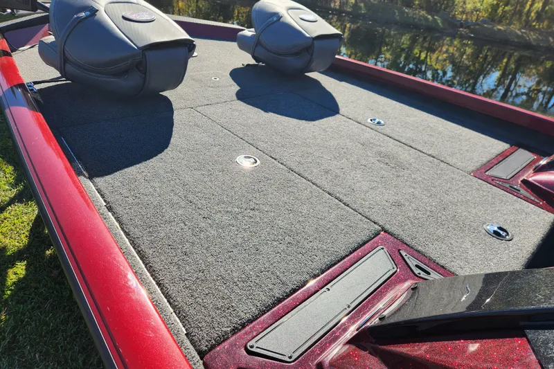 Slide: The Image of 2016 Ranger RT188 boat deck with carpet and seating, near water. - 9