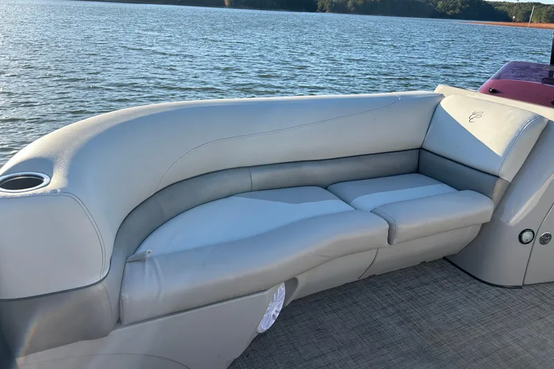 Slide: The Image of 2022 Cypress Cay Seabreeze 232 boat interior with comfortable seating on a lake. - 10