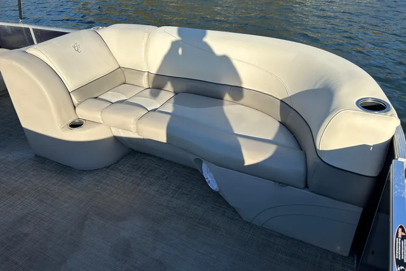 Slide: The Image of Luxurious seating on 2022 Cypress Cay Seabreeze 232 pontoon boat, with cup holders and water view. - 11