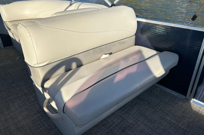 Slide: The Image of Cypress Cay Seabreeze 232 boat interior, 2022 model, featuring beige seating and water view. - 14