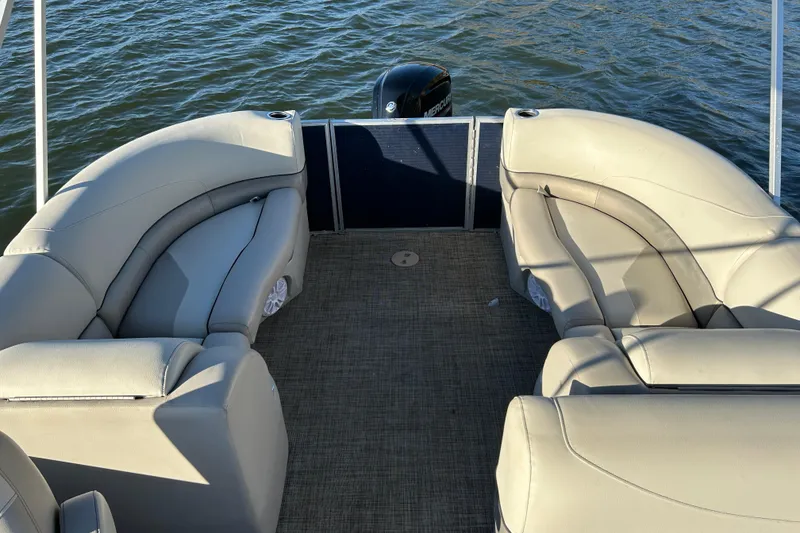 Slide: The Image of 2022 Cypress Cay Seabreeze 232 pontoon boat interior with beige seating and water view. - 15