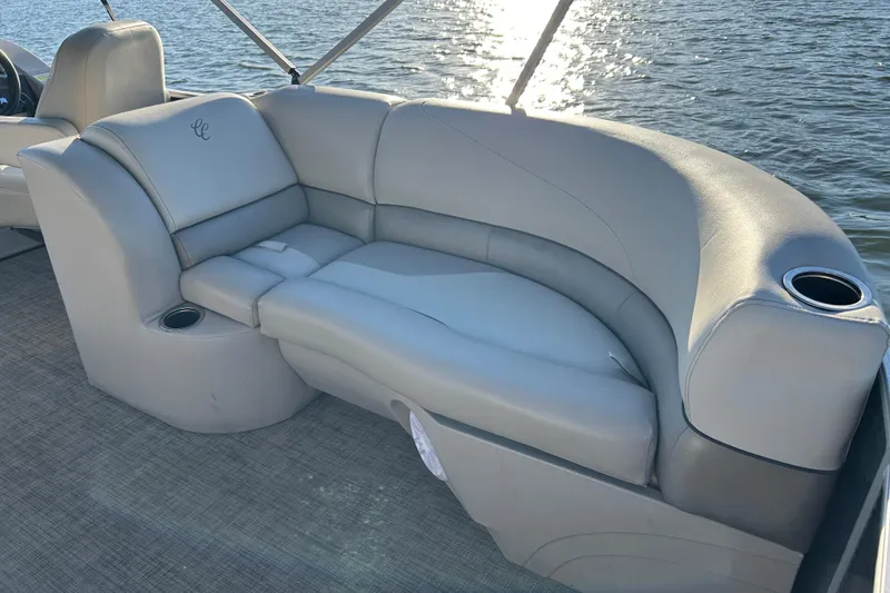 Slide: The Image of Luxurious seating on 2022 Cypress Cay Seabreeze 232 pontoon boat, with cup holders and water view. - 16